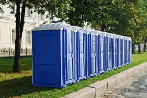 line of porta potties on the grass